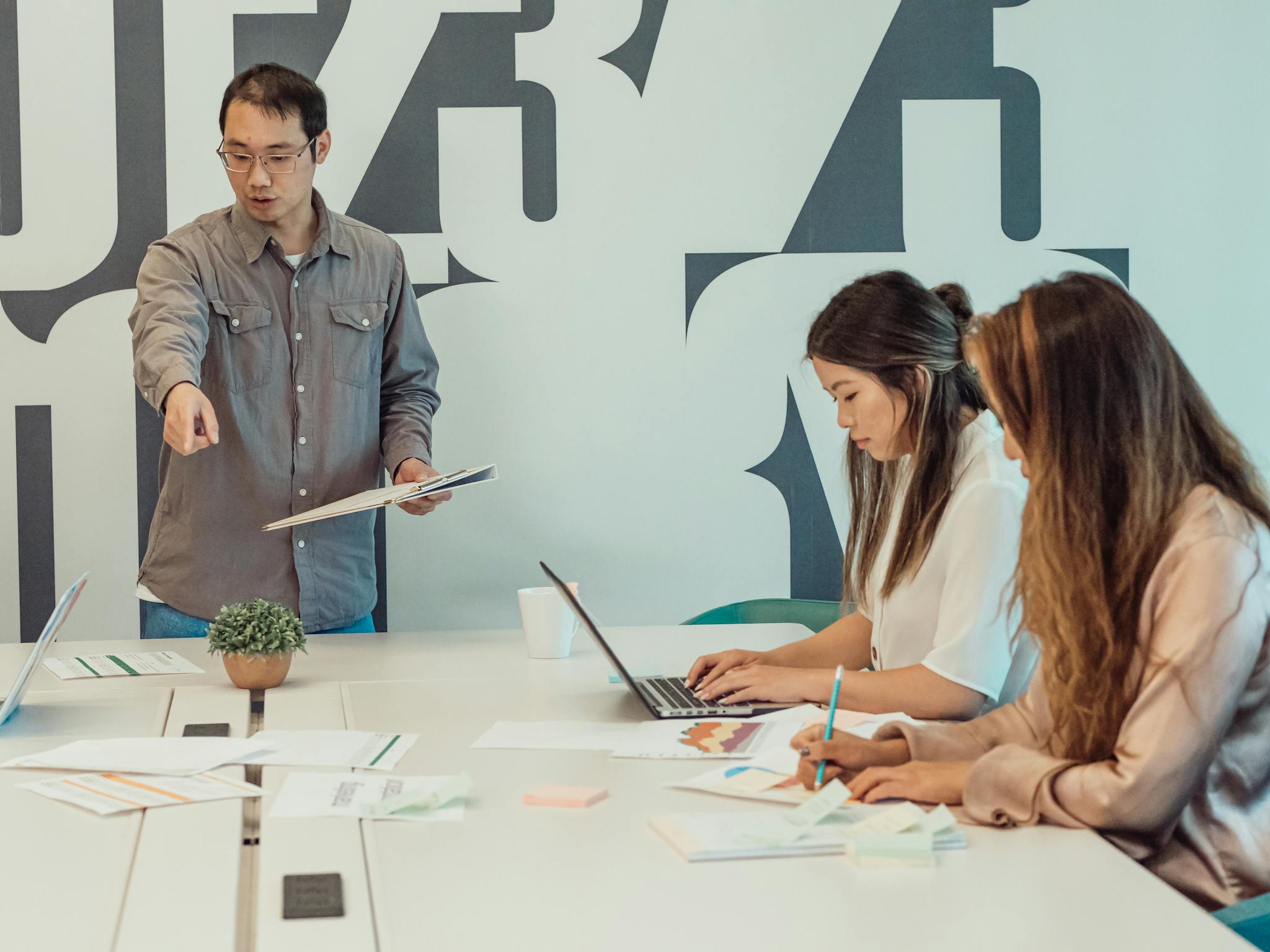 A diverse team in a startup office collaborating and brainstorming ideas for a project.